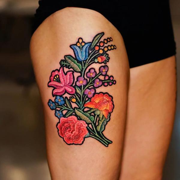 Flowers patch thigh tattoo