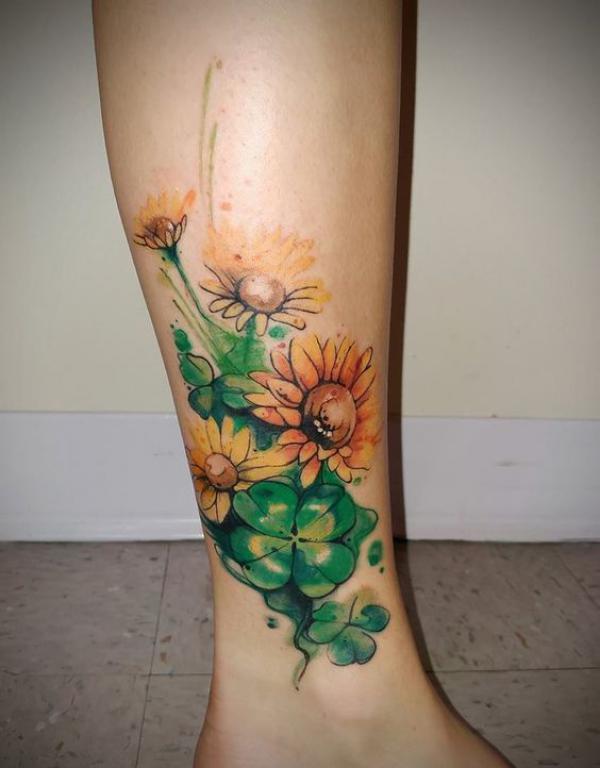 Four leaf clover and sunflower tattoo