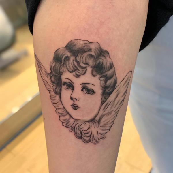 Girl cherub face tattoo