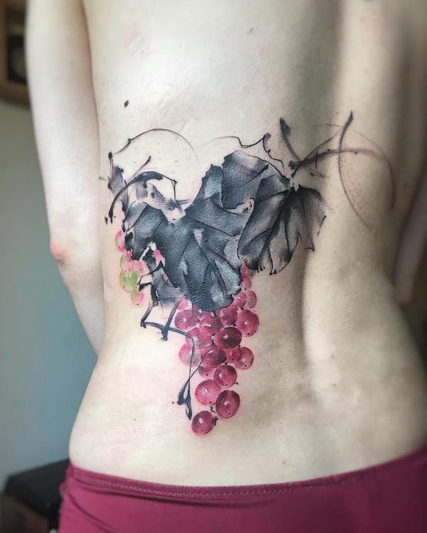 Grape tattoo on one side of lower back