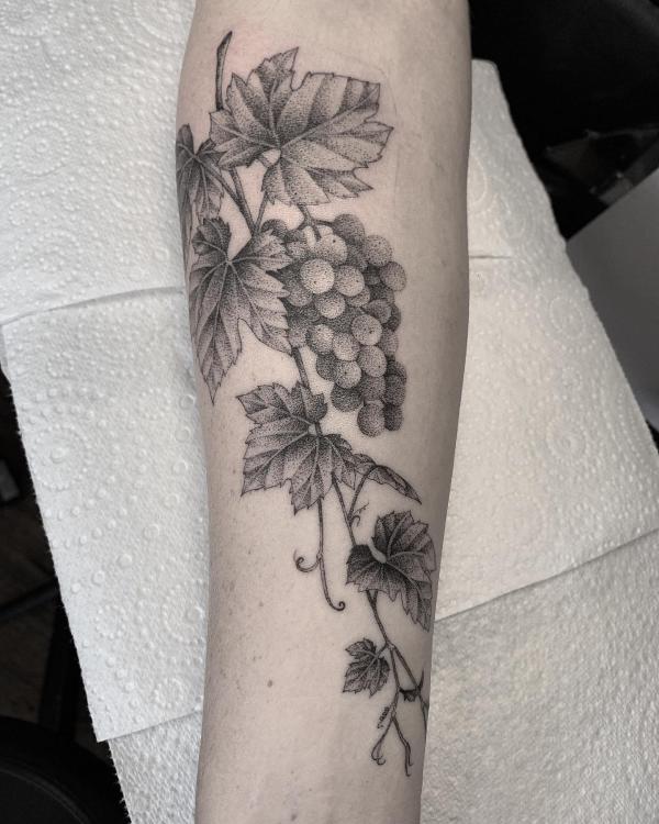 Grayscale grape forearm tattoo