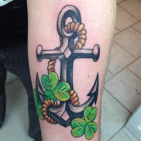 Greyscale anchor and green shamrocks tattoo