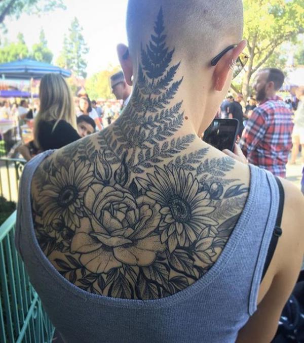 Greyscale rose and daisy with fern tattoo on upper back