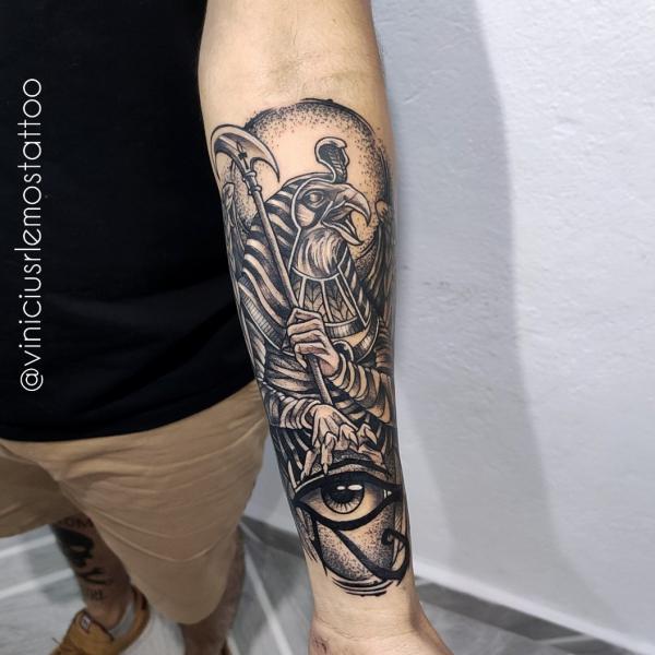 Horus holding a harpoon and eye of Horus tattoo