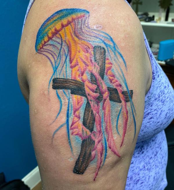 Jellyfish and wooden cross tattoo