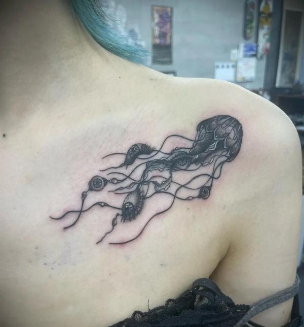 Jellyfish collarbone blackwork tattoo