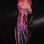 Jellyfish glow tattoo on black ink background