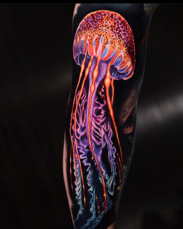 Jellyfish glow tattoo on black ink background