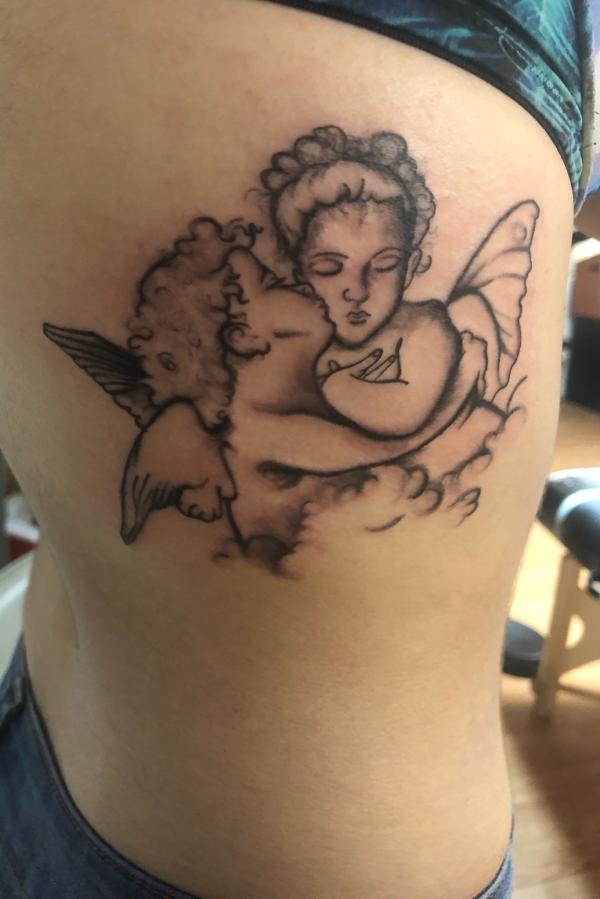 Kissing cherub tattoo
