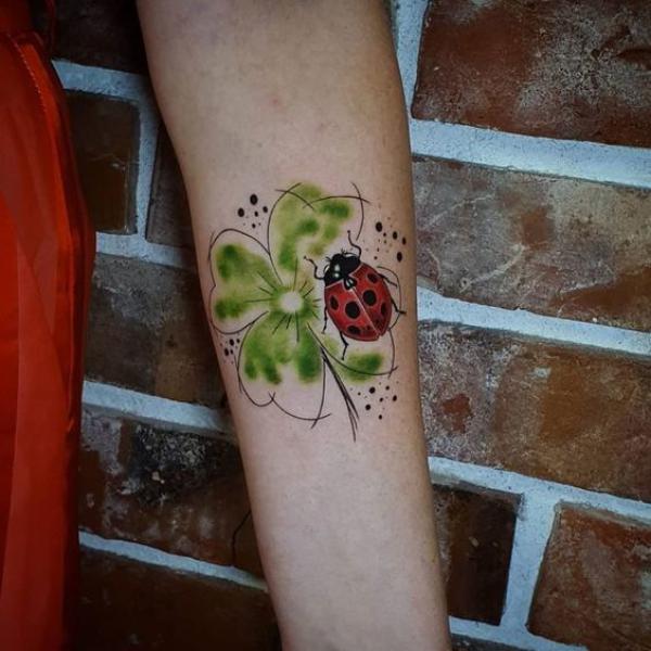 Ladybug with four leaf clover tattoo