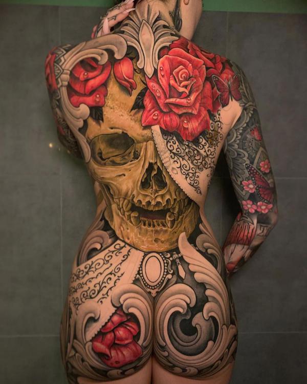 Large skull and rose full back and hip tattoo