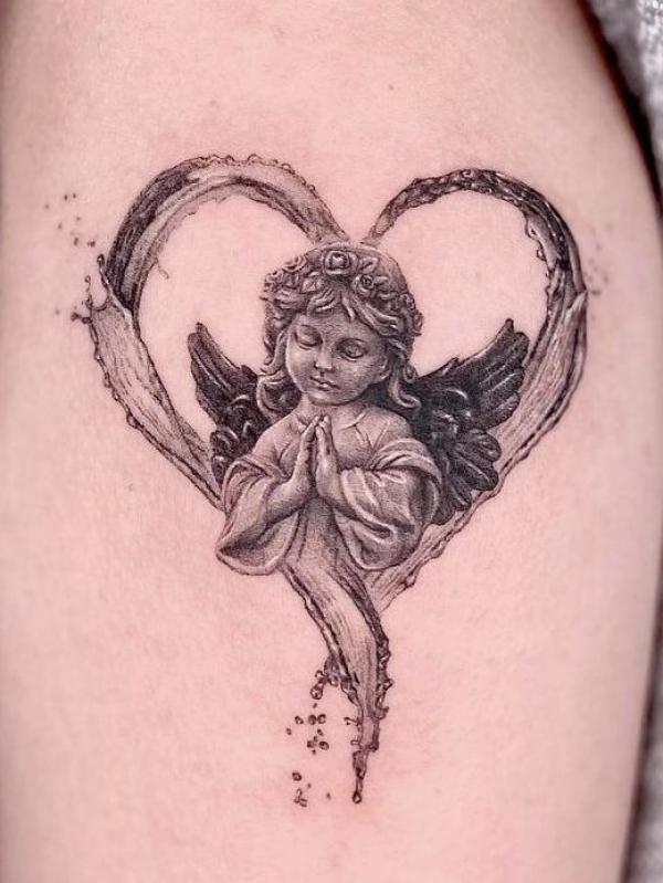 Loving cherub with praying hands tattoo