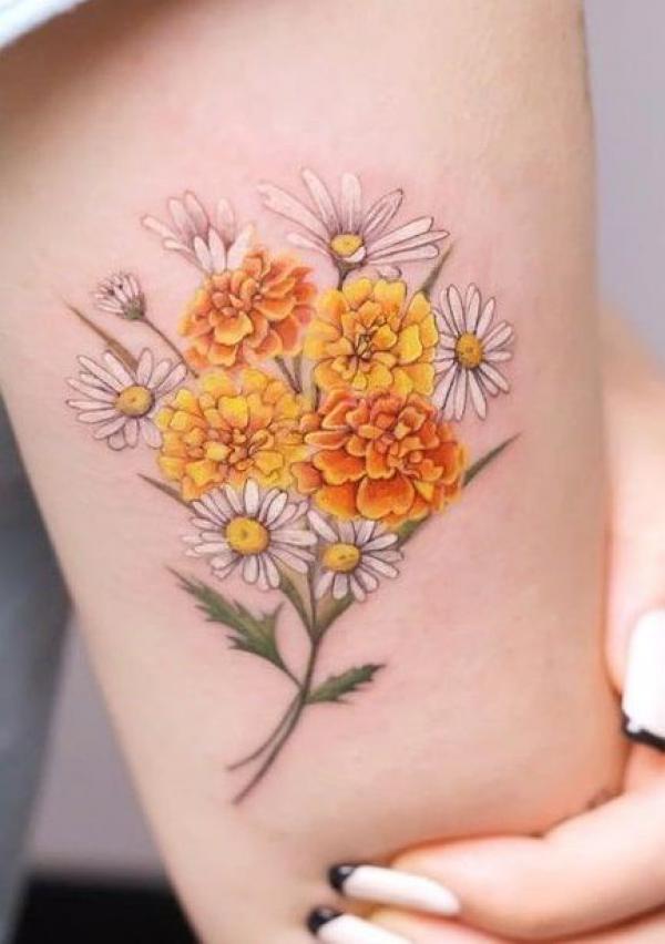 Marigold and daisy tattoo