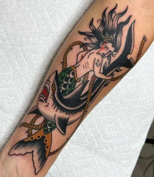 Mermaid catching a shark with a rope tattoo