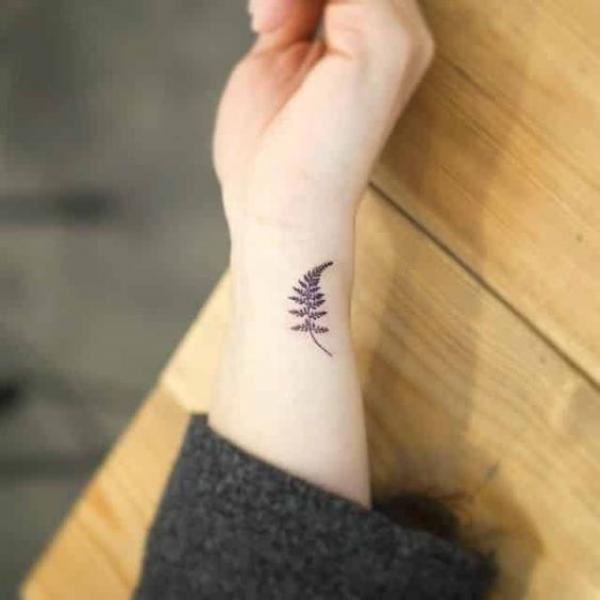 Minimalist fern tattoo on wrist