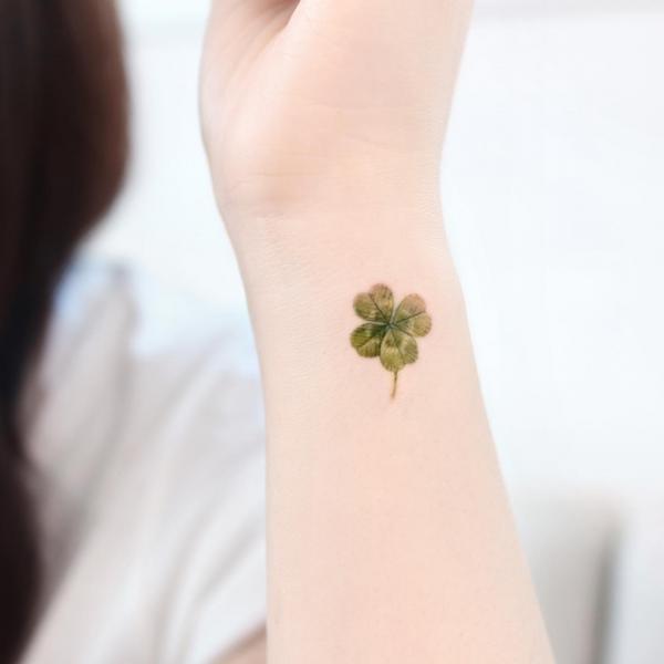 Minimalist four leaf clover tattoo
