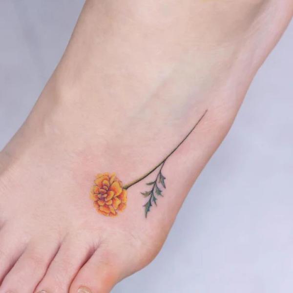 Minimalist marigold foot tattoo