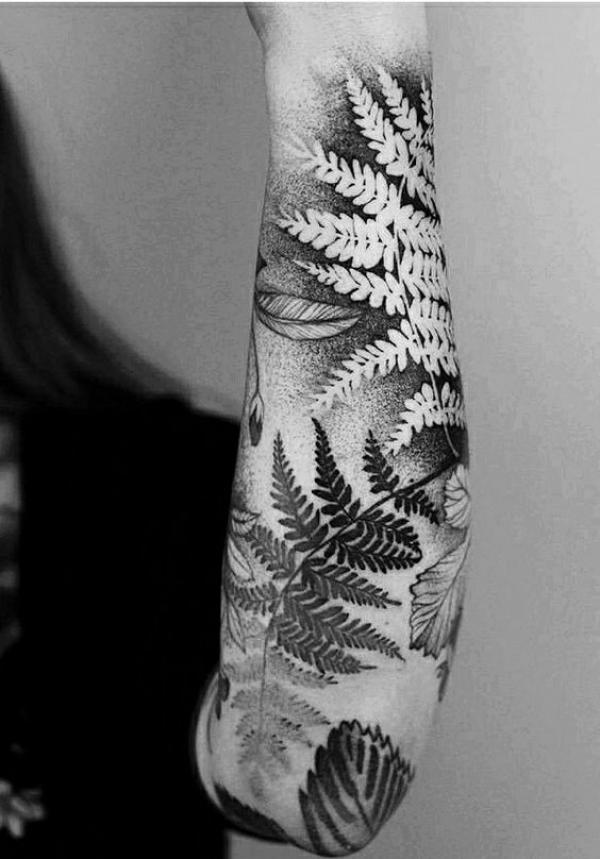 Positive and negative fern forearm tattoo