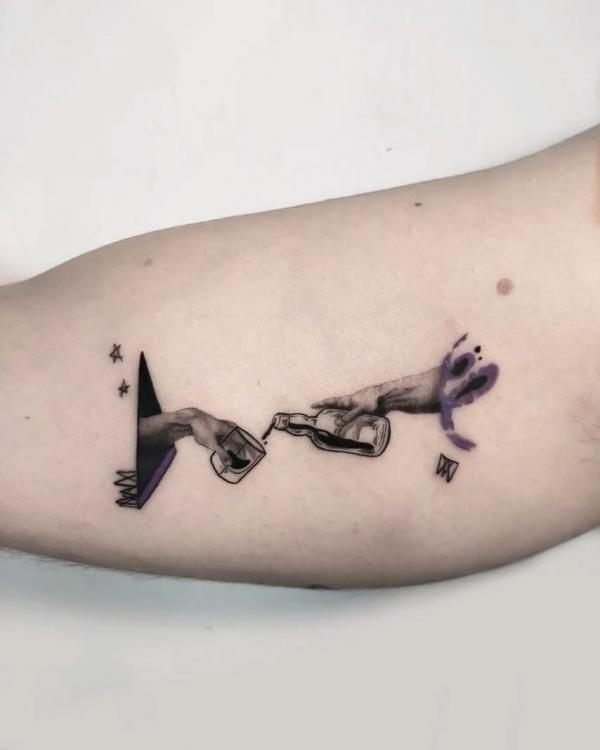 Pouring water from one bottle to a cup in another hand