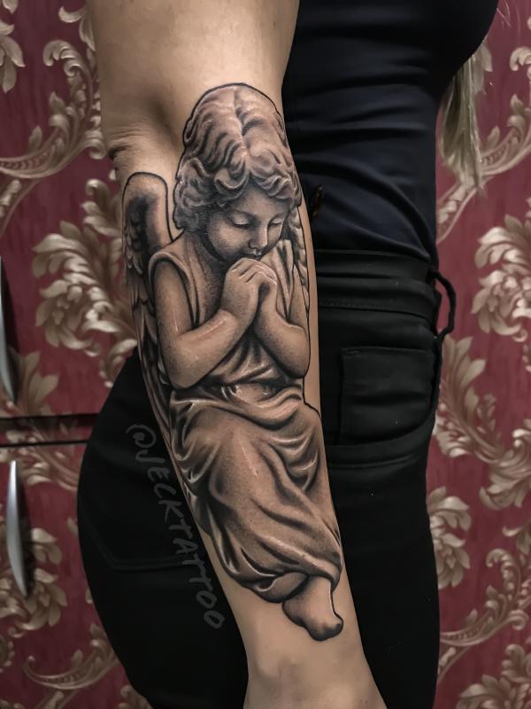 Praying cherub forearm tattoo