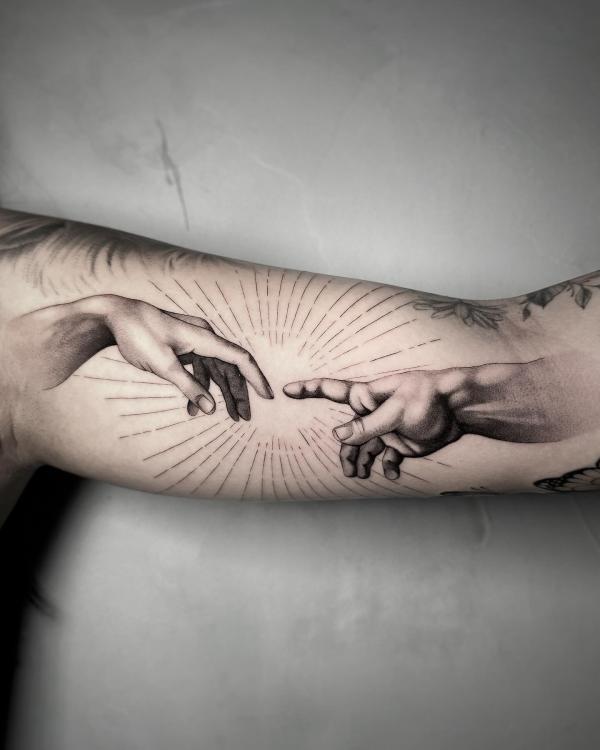 Realistic Adam hands bicep tattoo