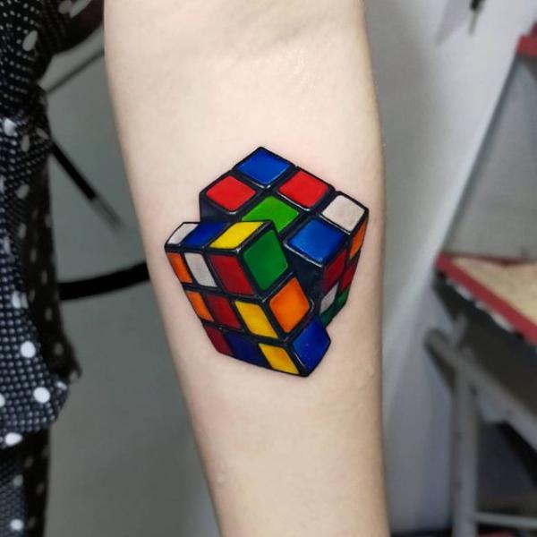Realistic Rubiks Cube tattoo on forearm