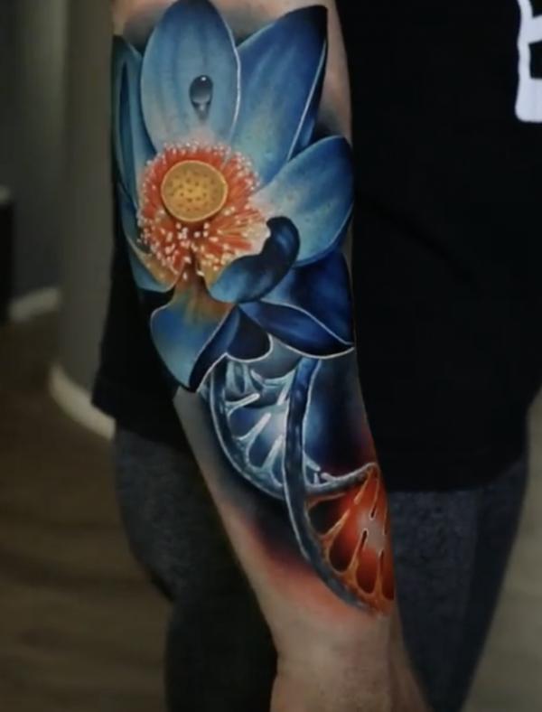 Realistic blue lotus forearm tattoo