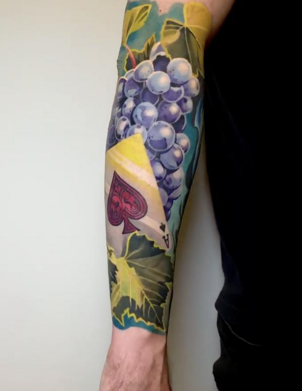Realistic grapes and Ace of spades tattoo sleeve