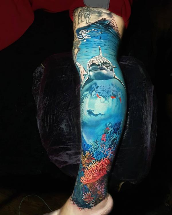 Realistic shark leg tattoo