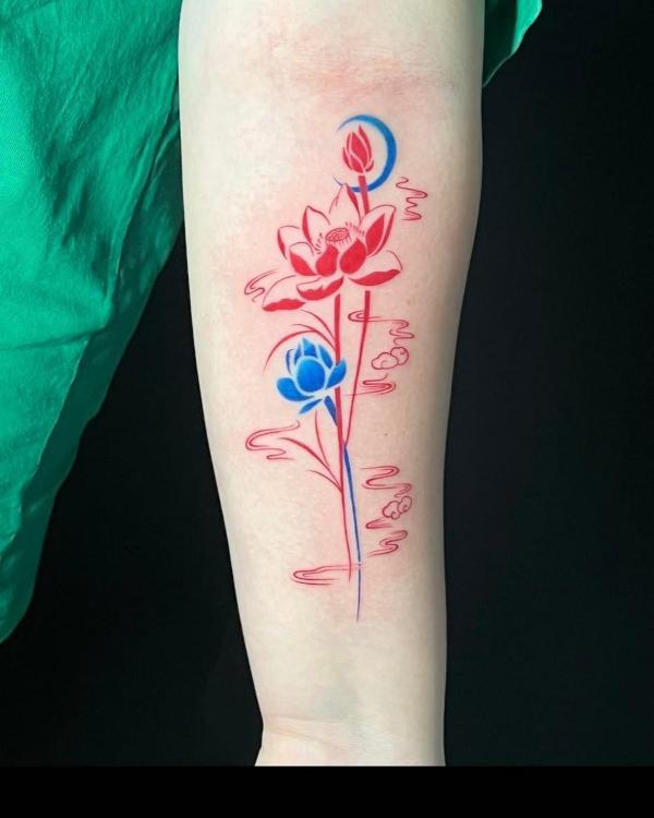 Red and blue lotus flowers tattoo