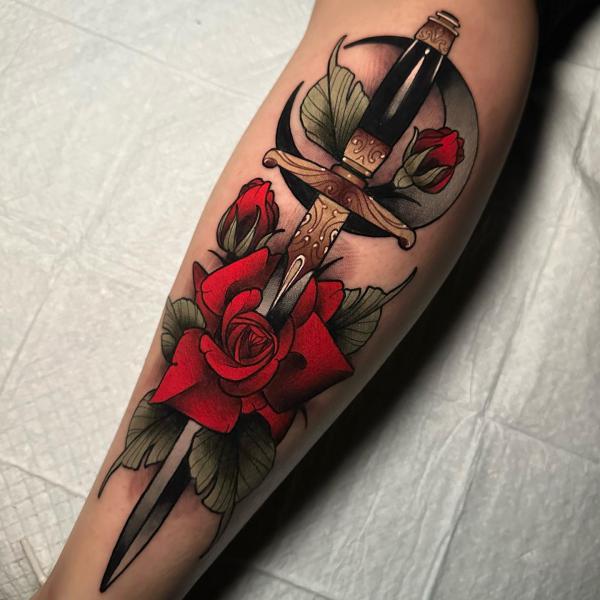 Red rose and dagger with crescent moon tattoo
