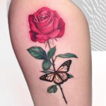 Red rose with stem and monarch butterfly tattoo