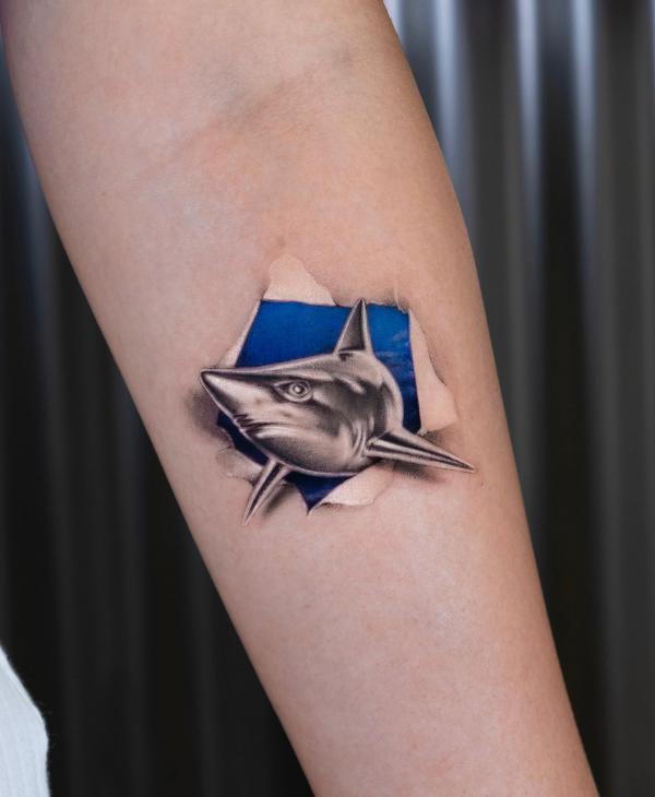 Ripped skin shark head tattoo