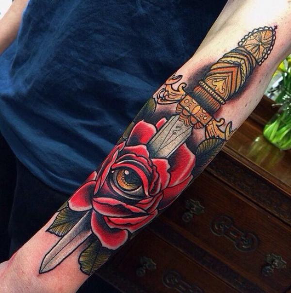 Rose and dagger arm tattoo traditional