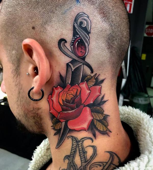Rose and dagger head neck tattoo