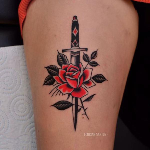 Rose and dagger thigh tattoo