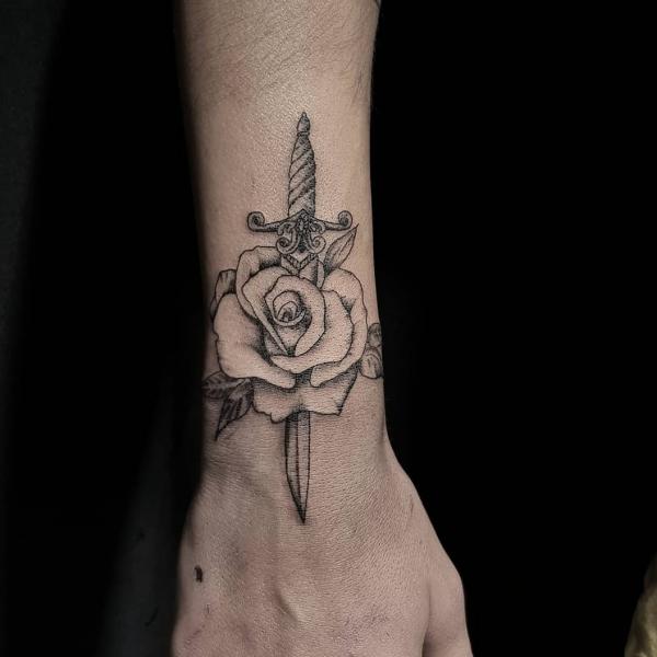 Rose and dagger wrist tattoo