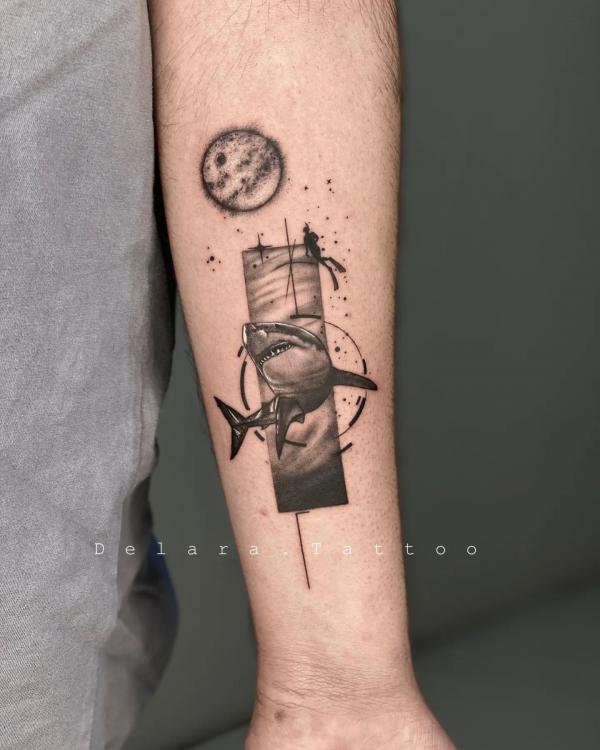 Shark diver and moon tattoo