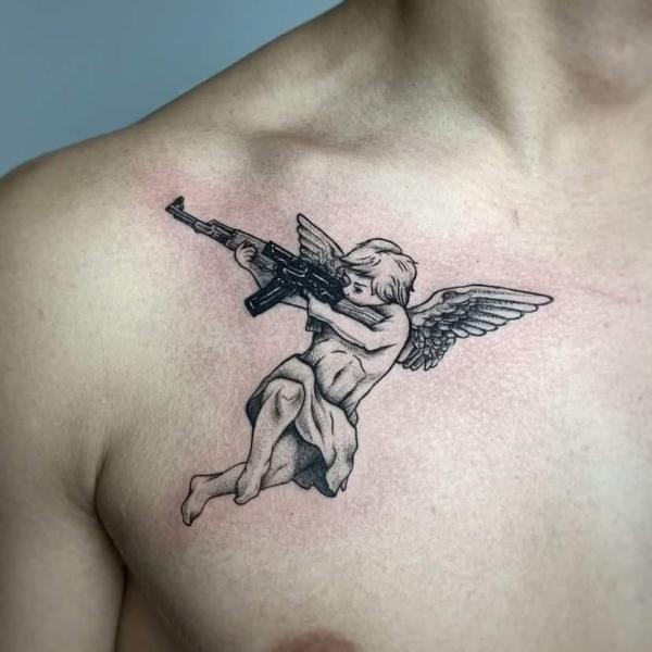 Shooting cherub chest tattoo