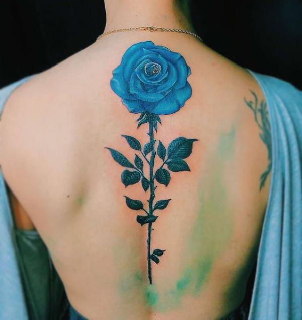 Single blue rose spine tattoo
