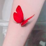 Single red butterfly tattoo