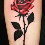 Single rose with thorns tattoo