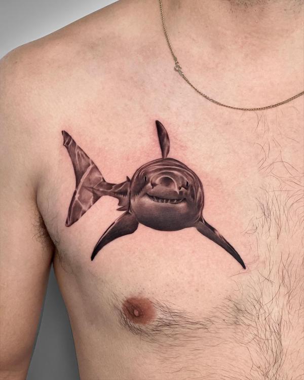 Single shark chest tattoo