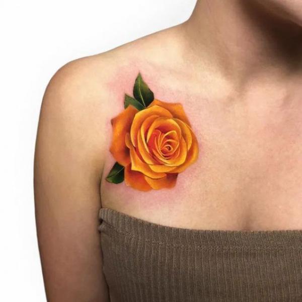 Single yellow rose chest tattoo