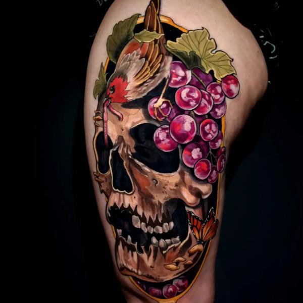 Skull with grapes and bird tattoo