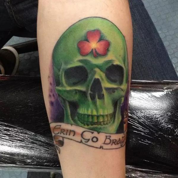 Skull with shamrock tattoo with words Grin Go Bravy