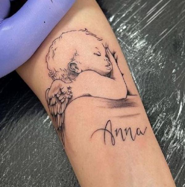Sleeping Cherub forearm tattoo