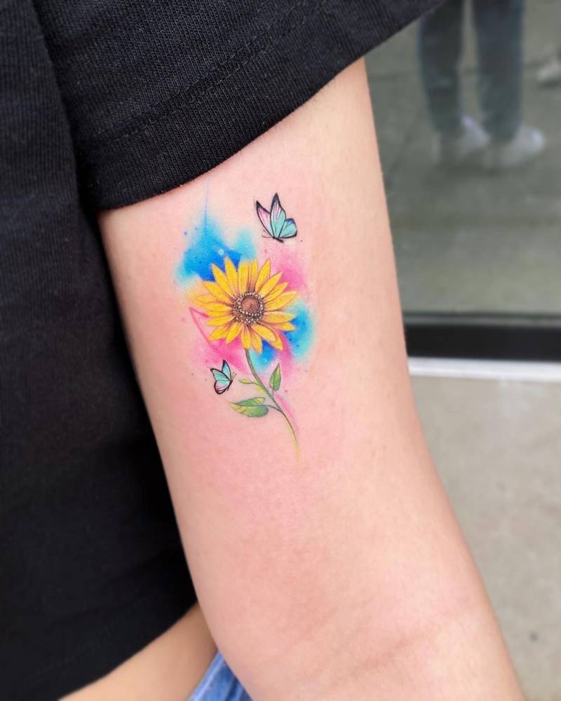Small Sunflower and butterfly tattoo on watercolor backdrop