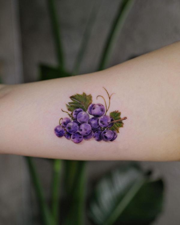 Small grapes forearm tattoo