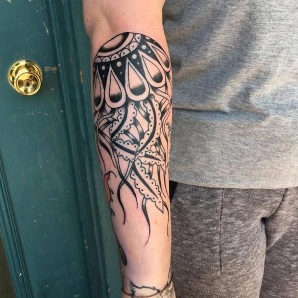 Stylized jellyfish forearm tattoo